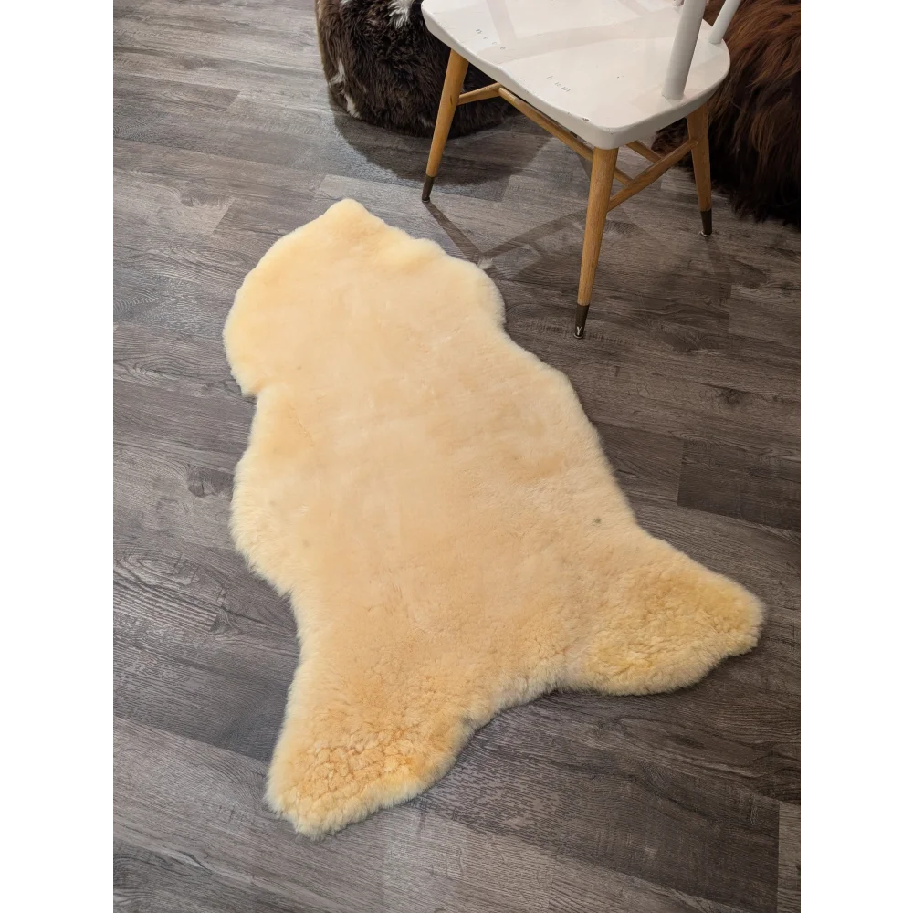 Cream-colored medical sheepskin rug with soft fluffy texture and natural edges by angus oliver extra large size