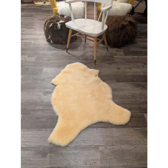 Cream-colored medical sheepskin rug with soft fluffy texture and natural shape by angus oliver medium size 43 x 28