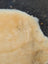 Cream-colored plush medical sheepskin with soft fluffy texture naturally spotted and washable for medical use