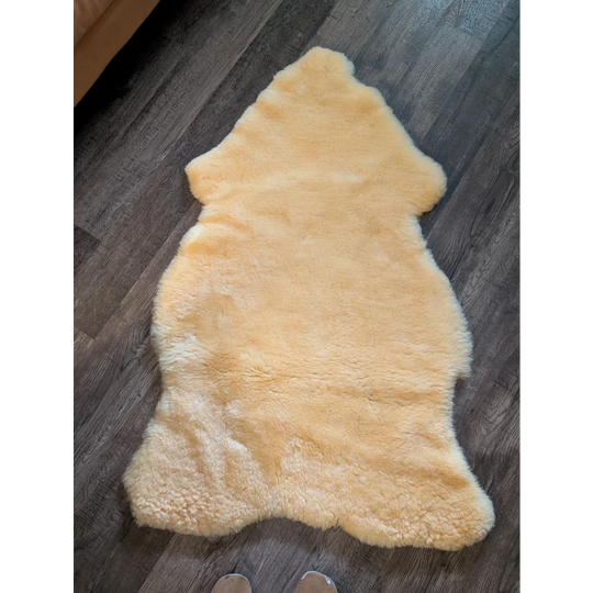 A soft pale yellow extra large medical sheepskin rug with fluffy texture by angus oliver for comfort and care