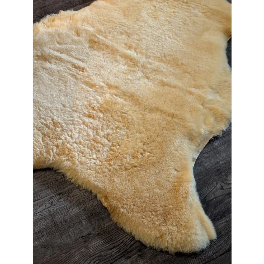 Cream-colored medical sheepskin rug with soft fluffy texture natural edges extra large by angus oliver