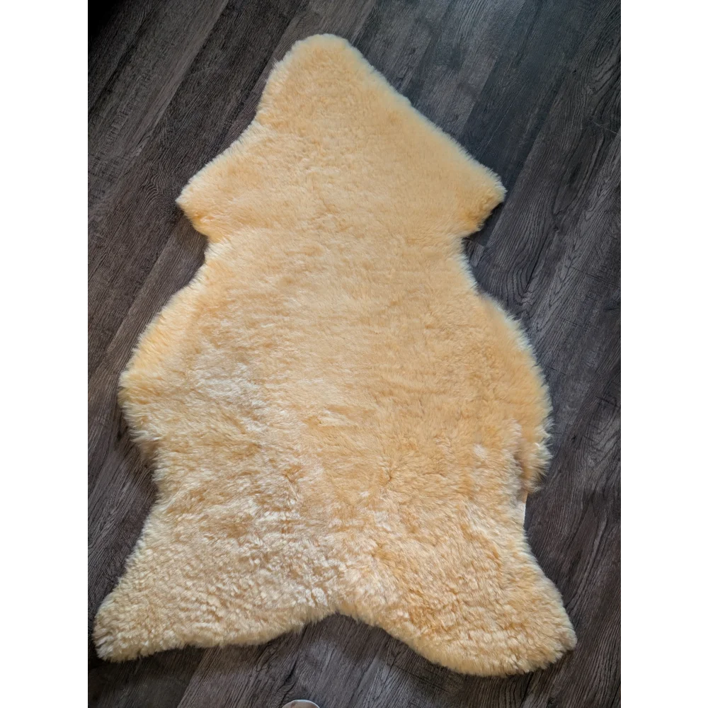 Cream-colored extra large medical sheepskin rug with natural fluffy texture and irregular edges by angus oliver