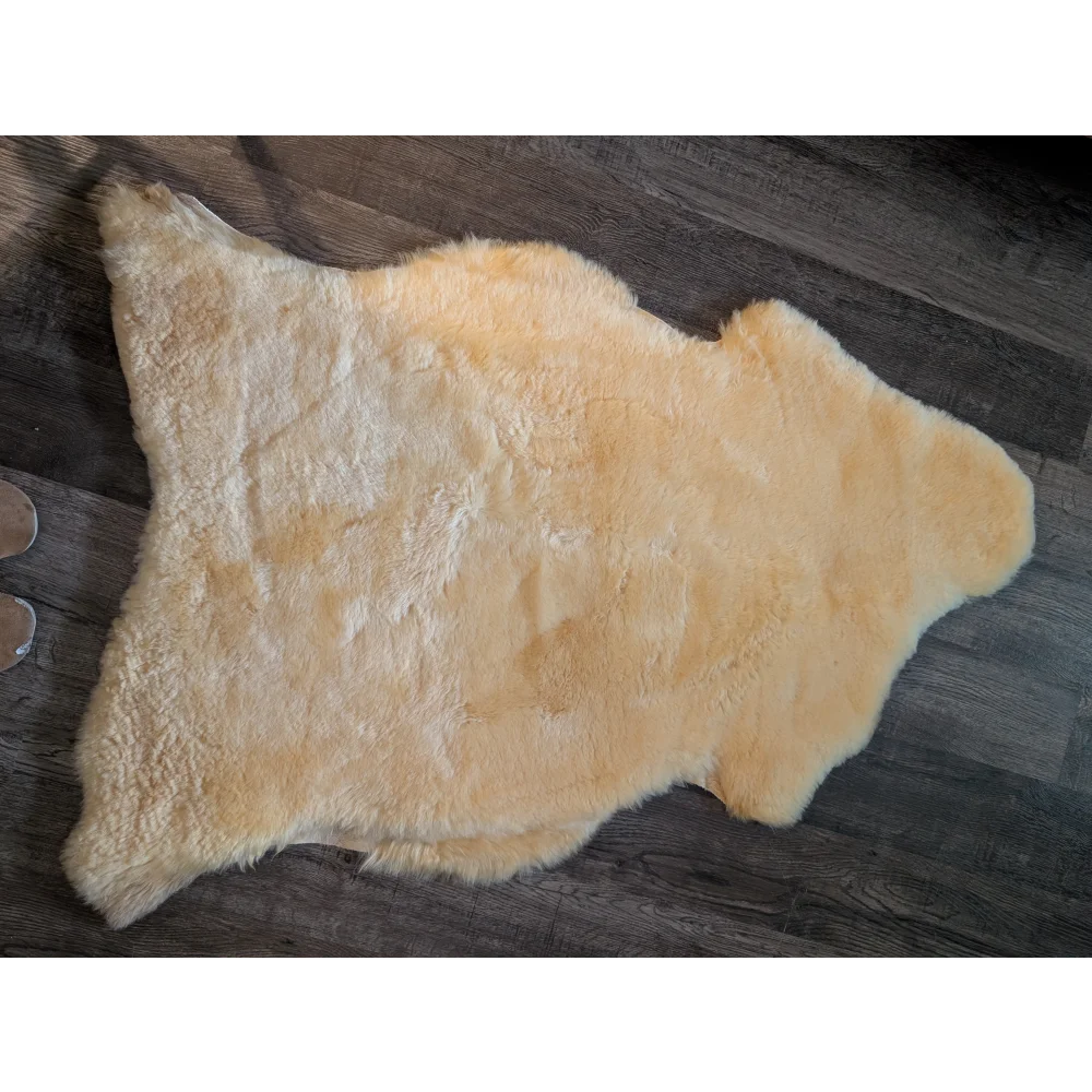 Cream-colored extra large medical sheepskin rug with soft fluffy texture and natural edges by angus oliver