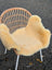 A cozy light beige washable medical sheepskin blanket draped over a wicker chair from angus oliver british sheepskins