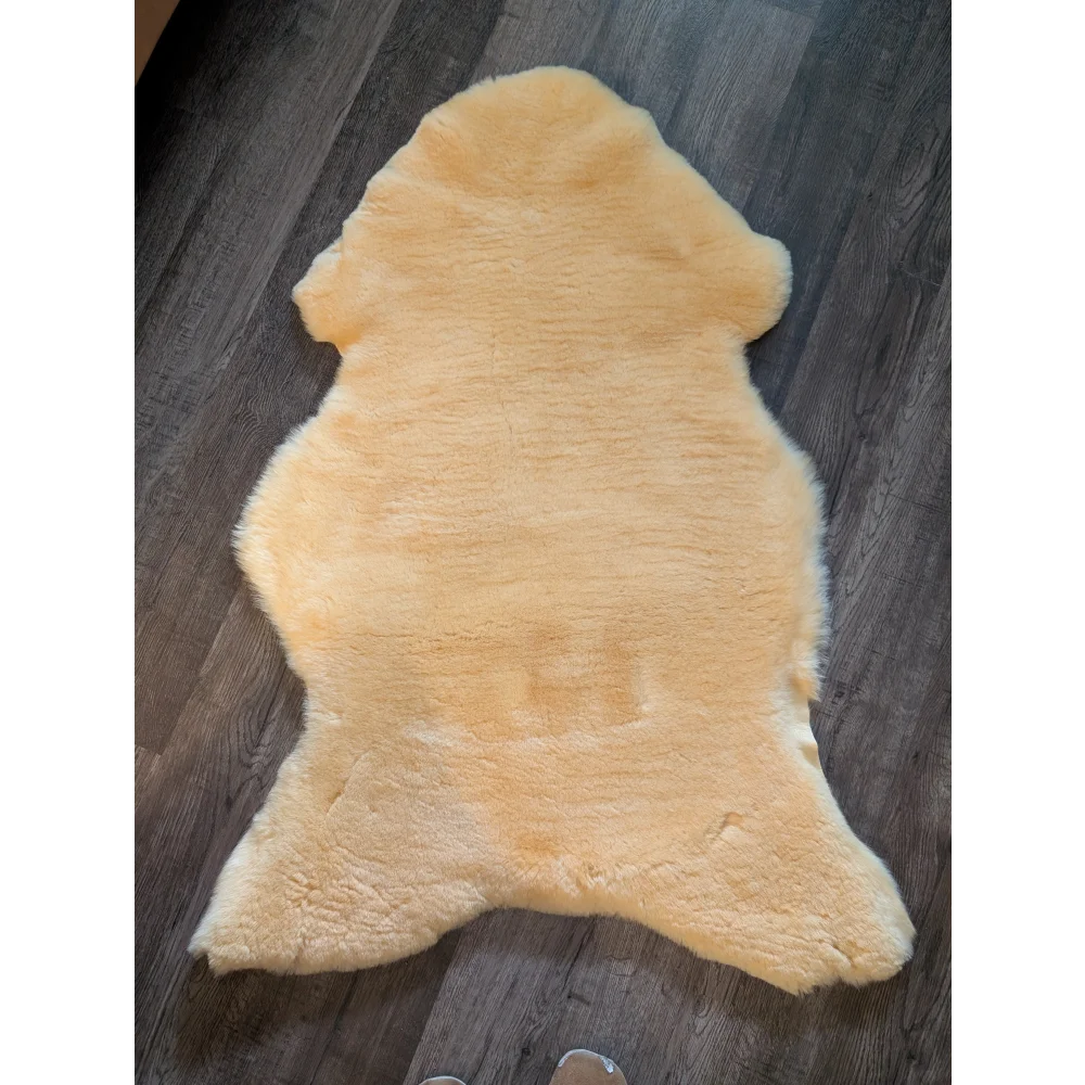 A soft pale yellow extra large medical sheepskin rug with natural fluffy texture by angus oliver