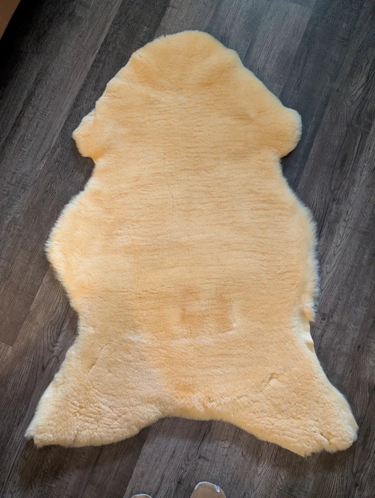 A soft pale yellow extra large medical sheepskin rug with natural fluffy texture by angus oliver