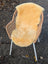 Woven wicker chair with white metal legs draped in soft golden-yellow angus oliver medical sheepskin blanket
