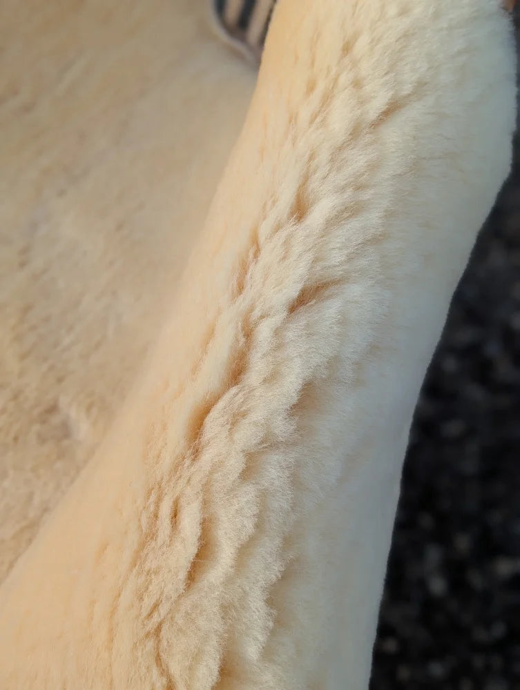 Cream-colored plush medical sheepskin with soft textured surface in 51 x 31 washable medical sheepskins for comfort