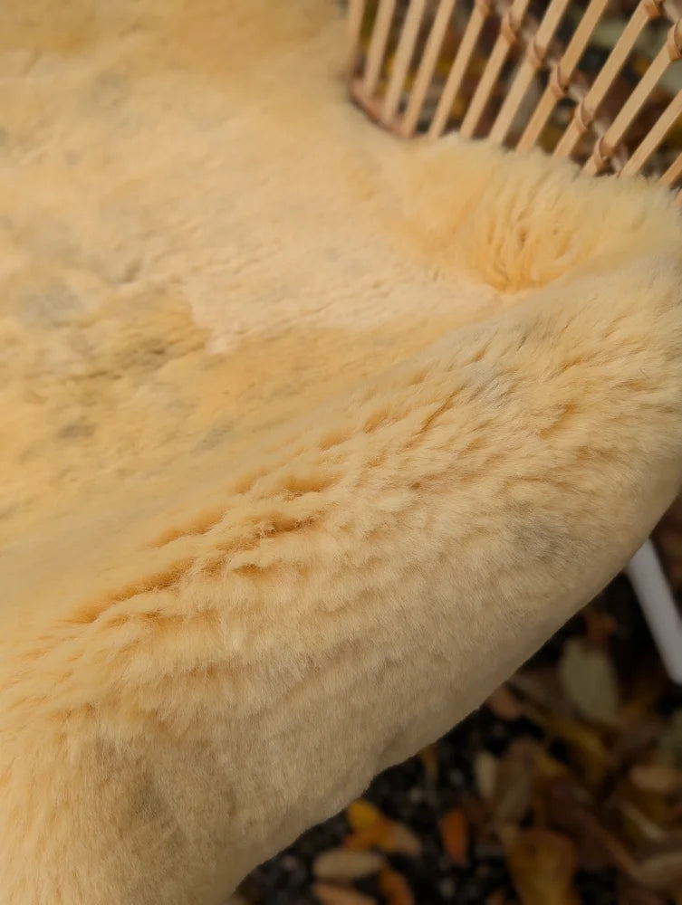 Cream-colored medical sheepskin rug with soft fluffy texture naturally spotted and washable for medical use