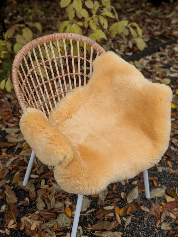 Warm golden brown washable medical sheepskin chair cover with soft fluffy texture by angus oliver