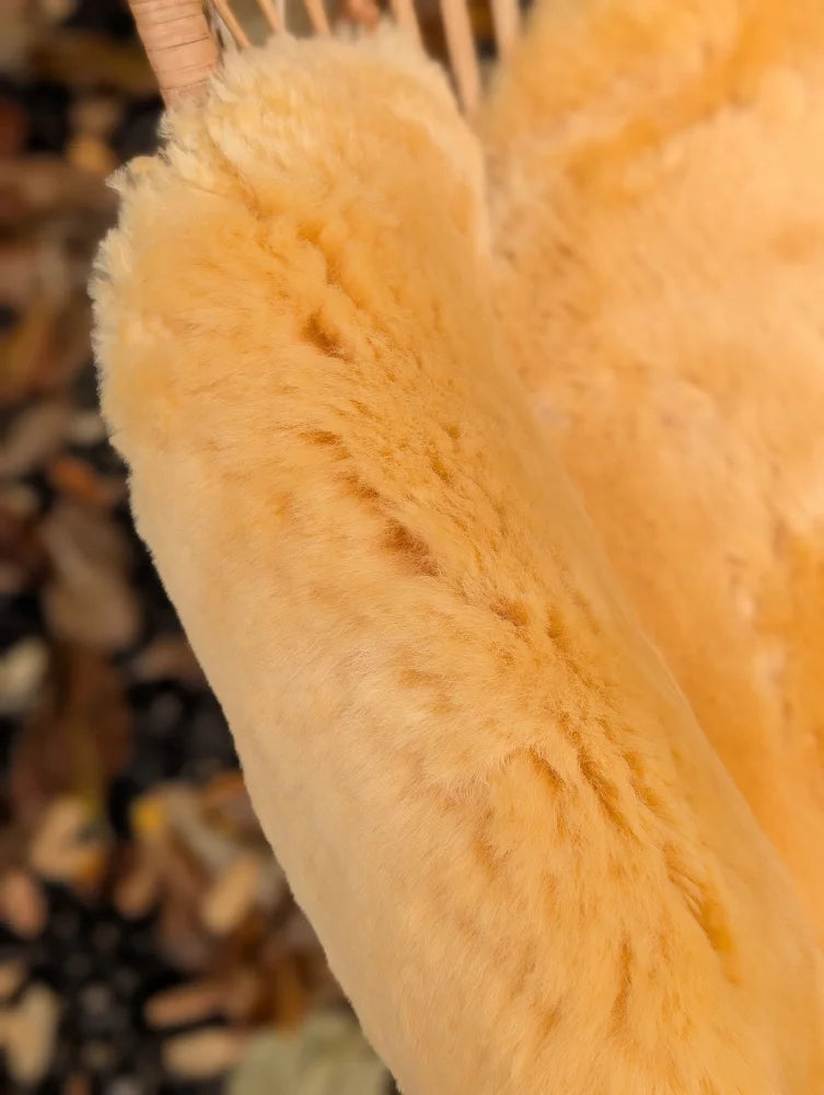 Soft golden-yellow medical sheepskin bath sponge with plush fluffy texture from angus oliver washable sheepskins