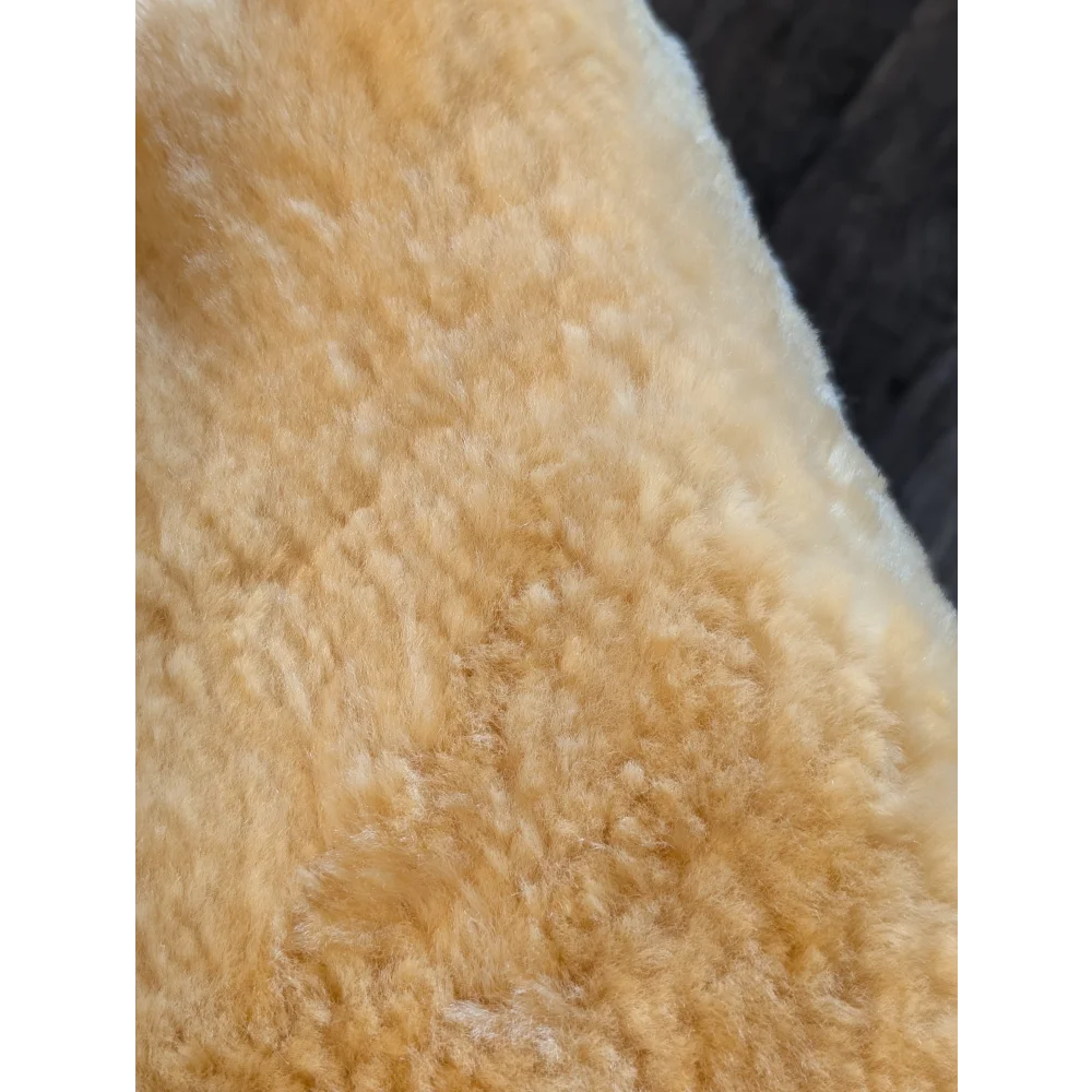Soft creamy beige medical sheepskin with plush curly texture medium medical sheepskin by angus oliver