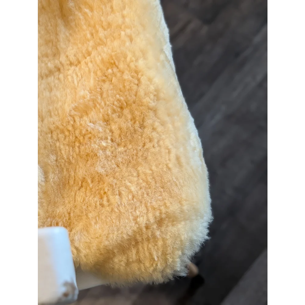 A plush golden-yellow medium medical sheepskin blanket with soft fluffy texture by angus oliver perfect for medical use