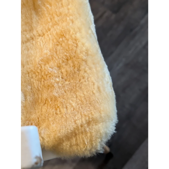 A plush golden-yellow medium medical sheepskin blanket with soft fluffy texture by angus oliver perfect for medical use