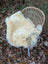 A cream-colored washable medical sheepskin rug with natural fur texture and naturally spotted grayish-brown speckles