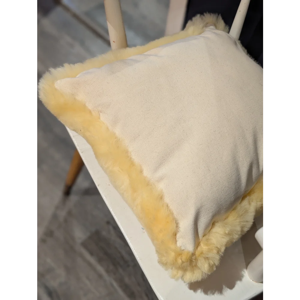 Cream-colored medical sheepskin cushion with soft fluffy yellow fur trim perfect for cushion cover use