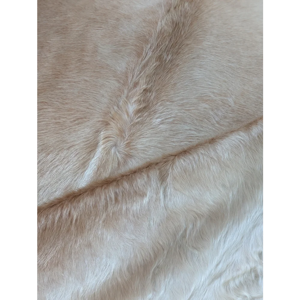 Medium beige angus oliver faux fur rug with soft plush texture and natural hairline patterns large cowhide style beautiful rugs