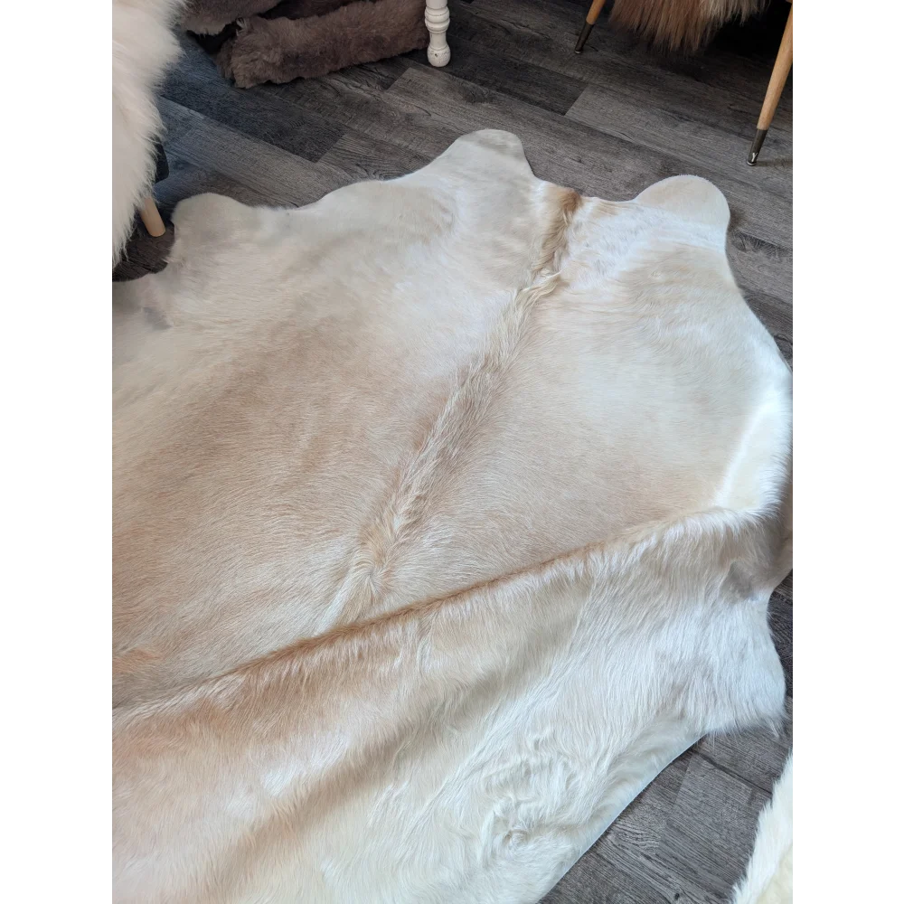 Medium 190 very soft large cowhide rug by angus oliver in cream with natural fur texture and subtle tan edges