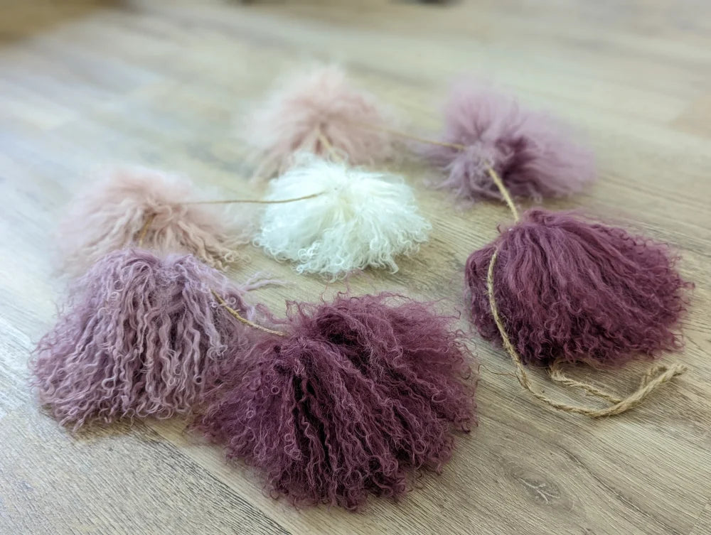 Medium pink sheepskin pom pom with lavender tassel garland