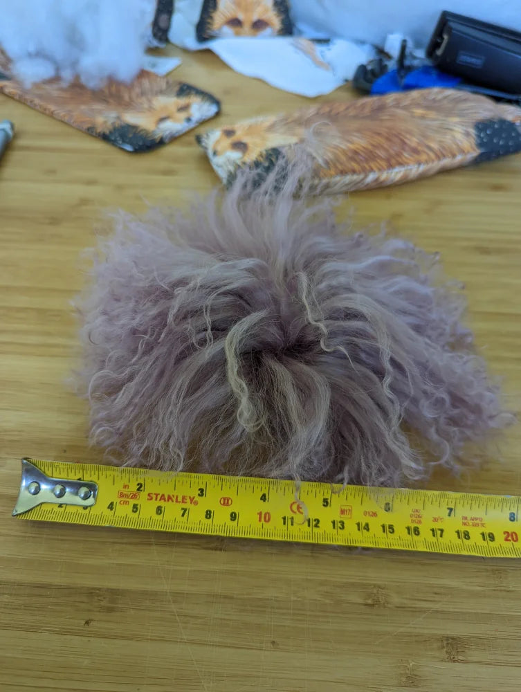 10-inch yellow Stanley tape measure with medium pink sheepskin pom pom