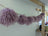 Medium pink sheepskin pom pom with lavender curly fur pillow