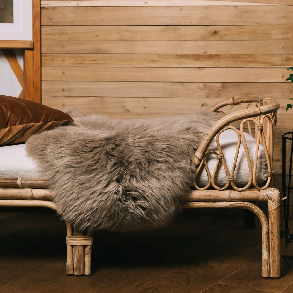 Rattan pet bed with plush gray dyed merino sheepskins blanket meeting strict european standards