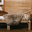 Rattan pet bed with plush gray dyed merino sheepskins blanket meeting strict european standards