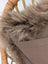 Cozy medium taupe merino sheepskin cushion cover with faux fur lining, glittery accents, and soft cotton backs