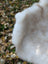 A plush off-white british isles sheepskin with soft dense faux fur and slightly uneven edges perfect for cozy décor