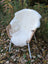 White british isles sheepskin throw draped over wicker chair with metal legs soft cozy decoration