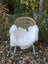 White faux fur throw made from british isles sheepskin draped over a wicker chair for cozy decor