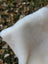A plush white faux fur throw blanket with soft fluffy texture from the british isles sheepskin collection