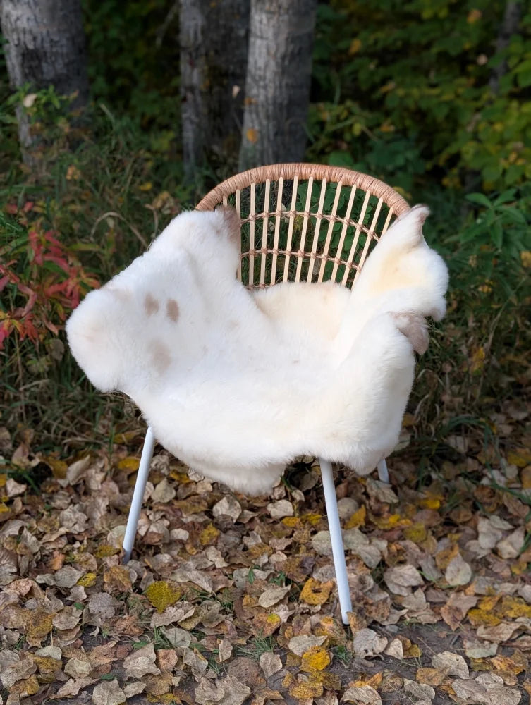 White british isles sheepskin throw draped over wicker chair mel7 45 x 29 soft cozy isles sheepskin rug