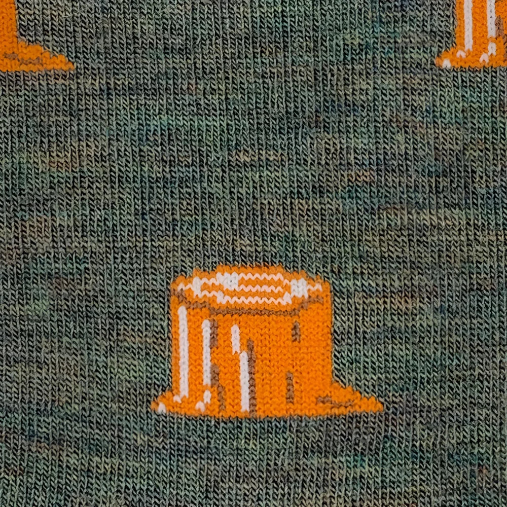 Orange knitted tree stump pattern on dark green merino wool socks perfect for warm hiking and trail use