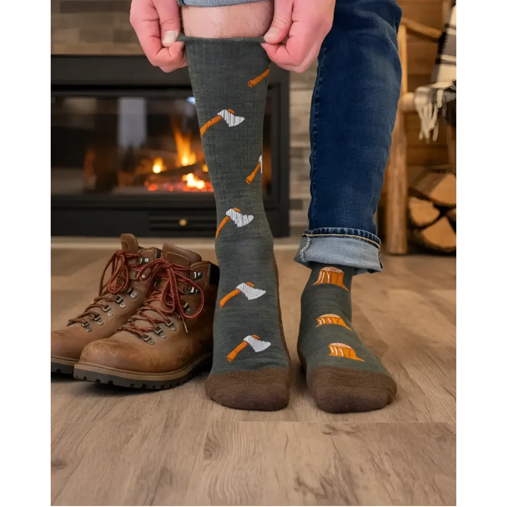 Dark gray merino wool socks with orange and white axe pattern worn with blue jeans perfect for hiking and trail use