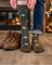 Dark gray merino wool socks with orange and white axe pattern worn with blue jeans perfect for hiking and trail use