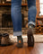 Dark olive green men’s merino wool socks with small orange tree stump and treasure sock co branding on heel for hiking
