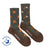 A pair of olive green and brown merino wool socks with orange tree stumps and axes perfect for hiking and trails
