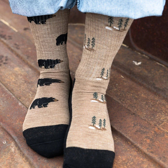 Beige merino wool socks with black bear and tree patterns and solid black toe cap perfect for trekking