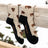 A pair of beige merino wool socks with brown bison prints and black toe and heel from friday sock co perfect for hiking