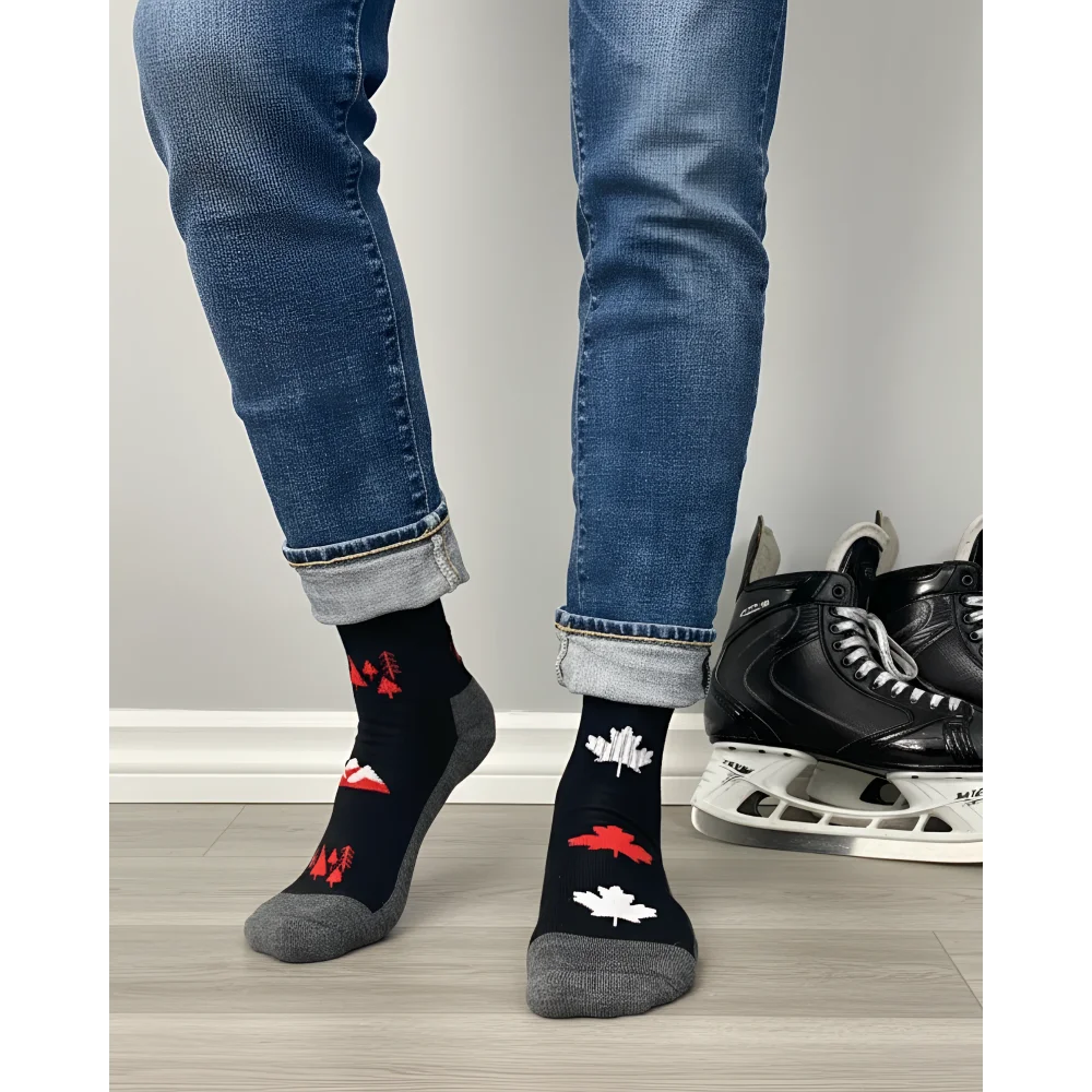 Men’s canada merino wool socks in black with red and white maple leaf designs and gray toe caps worn with cuffed jeans