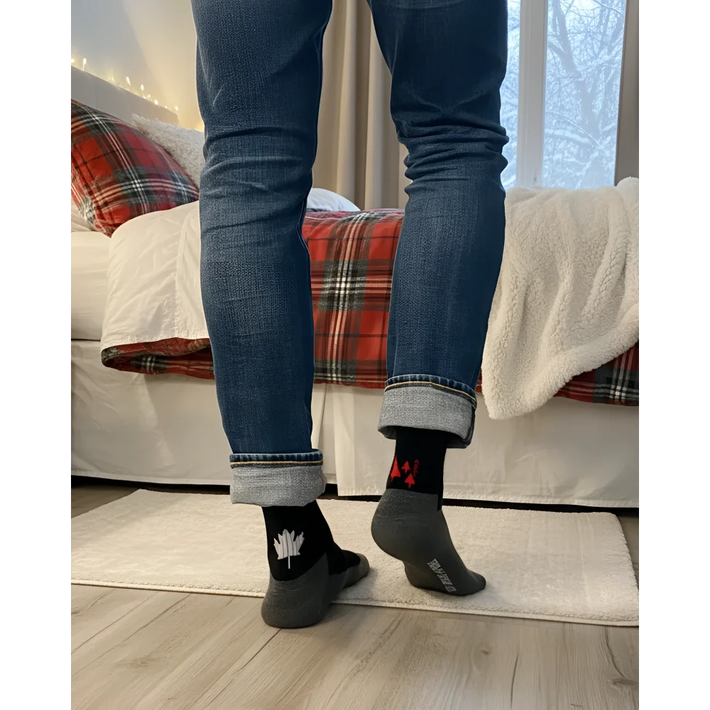 Men’s canada merino wool socks featuring black wool socks with white maple leaf and red heel accents worn with blue jeans