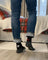 Men’s canada merino wool socks featuring black wool socks with white maple leaf and red heel accents worn with blue jeans