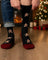 Men’s gingerbread bite merino wool socks in black with festive gingerbread pattern and maroon heel and toe accents