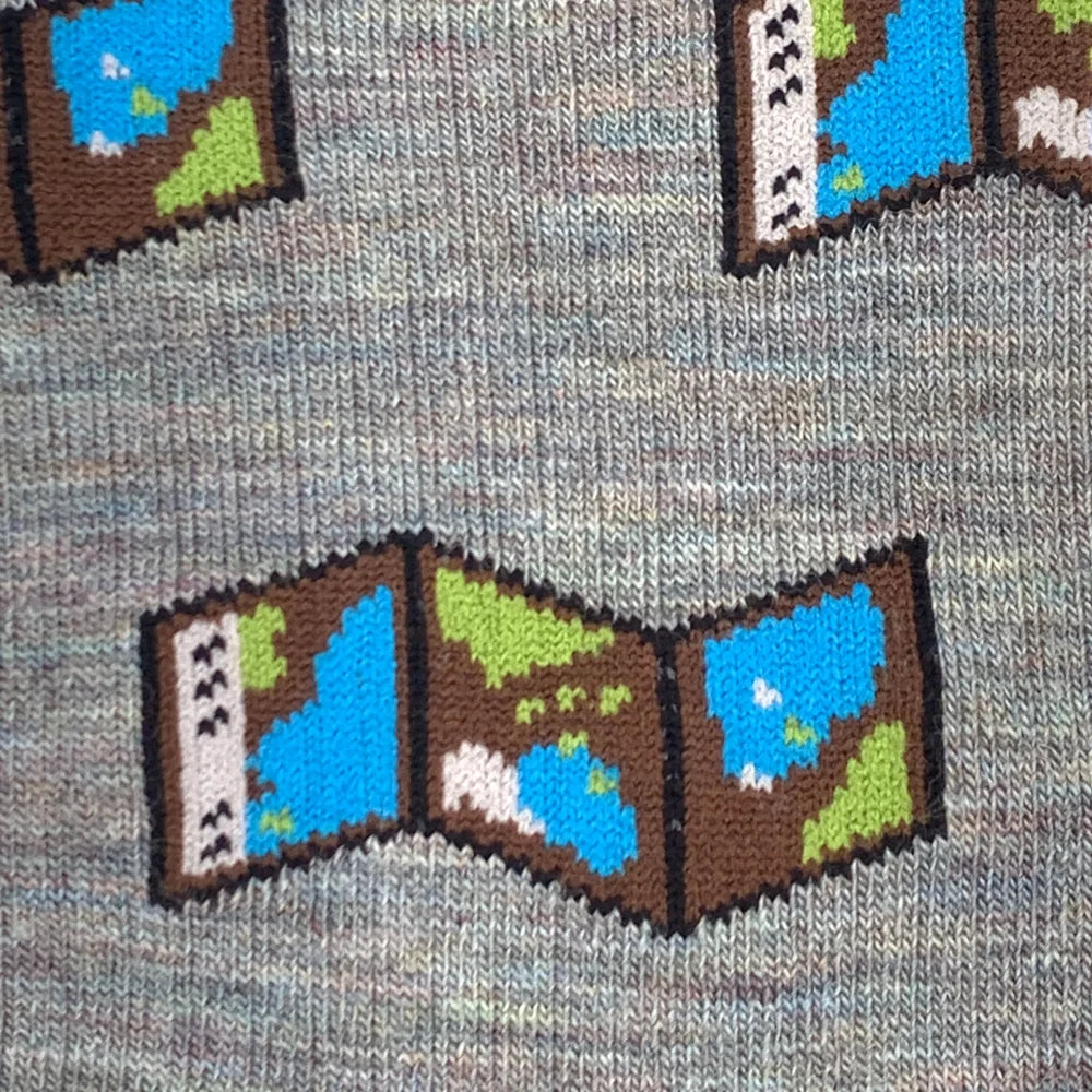 Gray merino wool socks with a pixelated map design featuring brown borders blue water and green landmasses