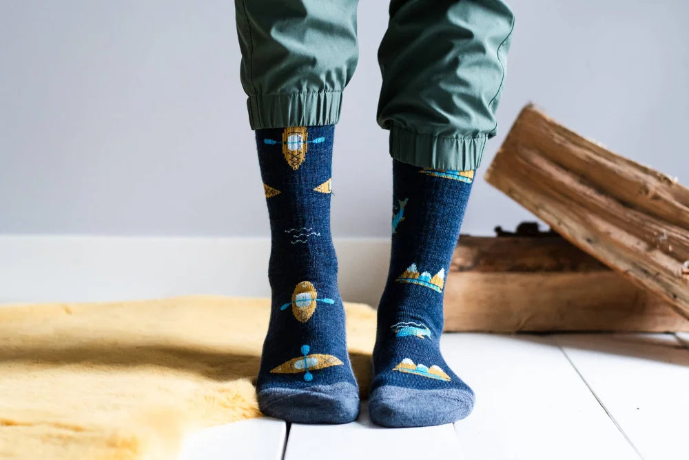 Dark blue merino wool socks with playful gold and light blue space patterns perfect for outdoor activity