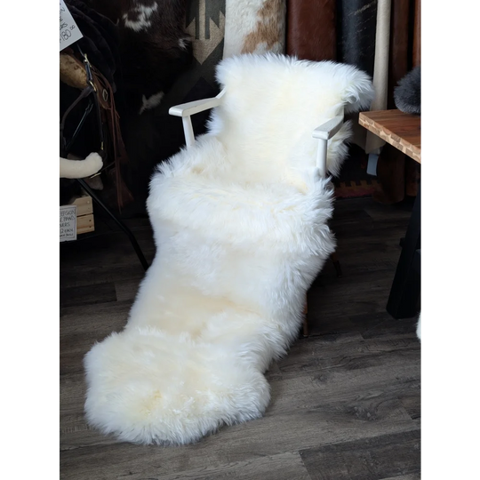 Oeko tex certified very soft merino double sheepskin on white armchair