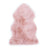 Soft pink dyed merino sheepskins with natural fluffy texture and irregular edges for cozy home decor