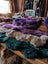 A plush multicolored merino sheepskin rug in purple teal and beige perfect for cozy home decor