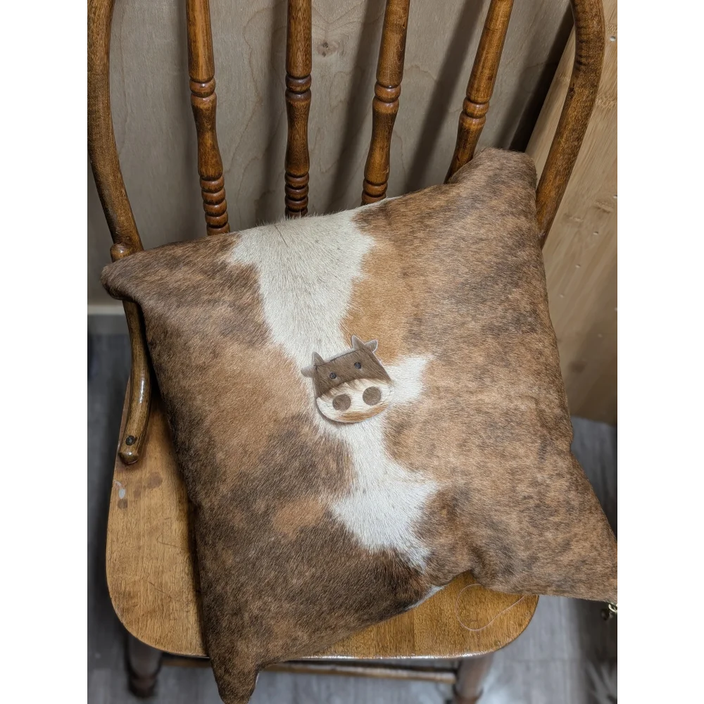 Brown and white mini moo double sided cowhide cushion with stitched on cow face design by angus oliver canada